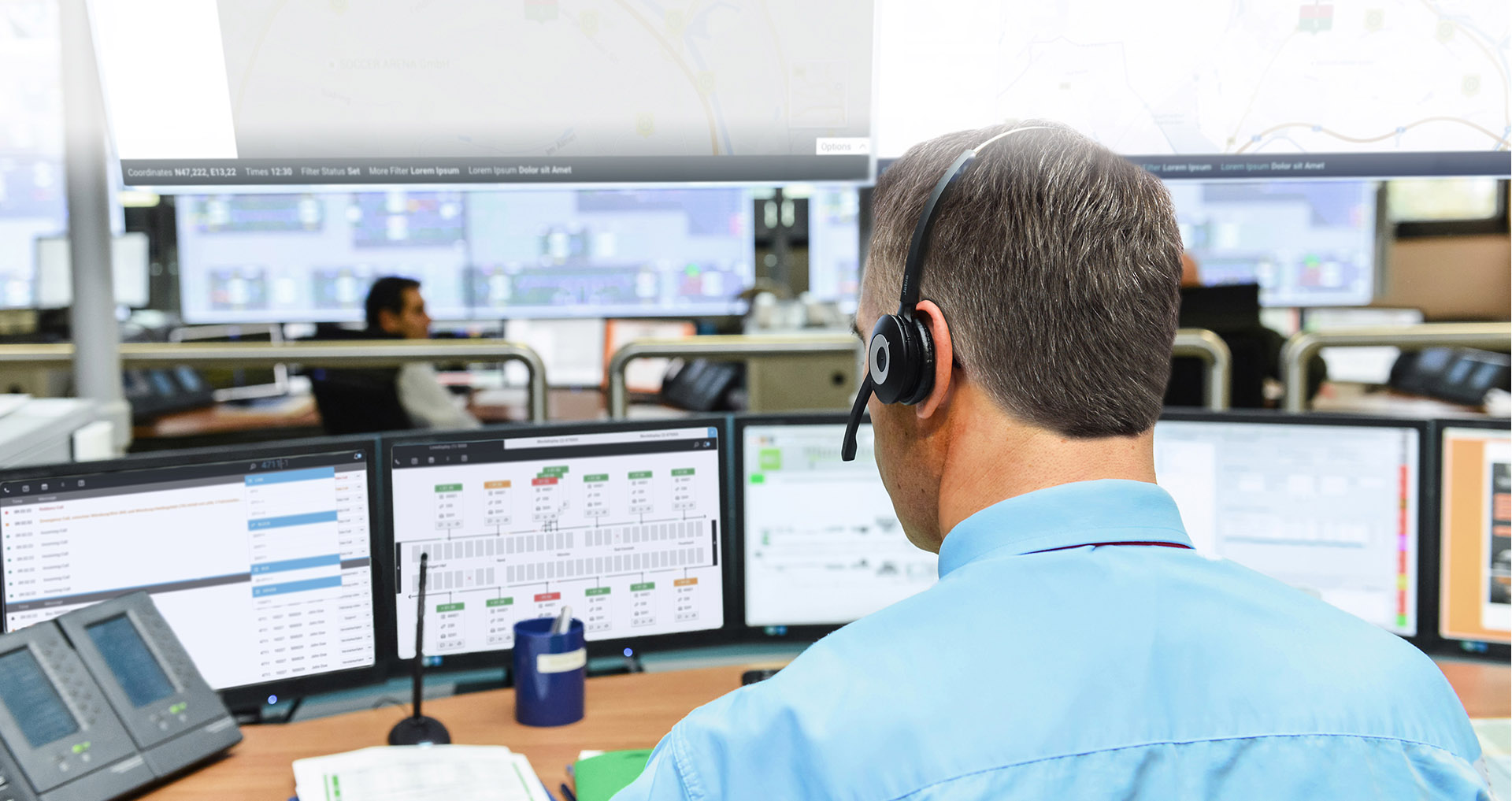 Dispatcher sitting in operations control room looking at screens.
